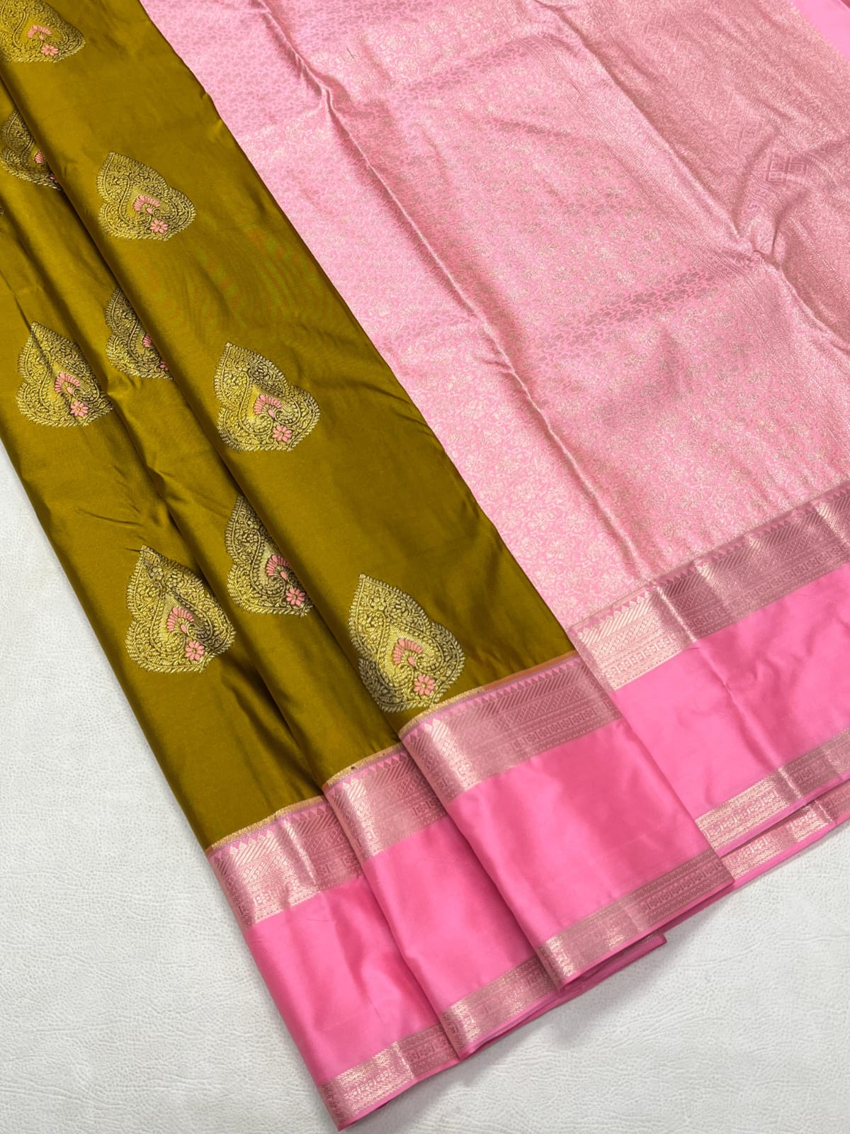 Sari with green and pink fabric on a white background