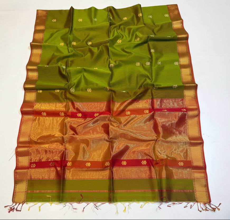 Green and gold traditional saree with intricate patterns on a white background
