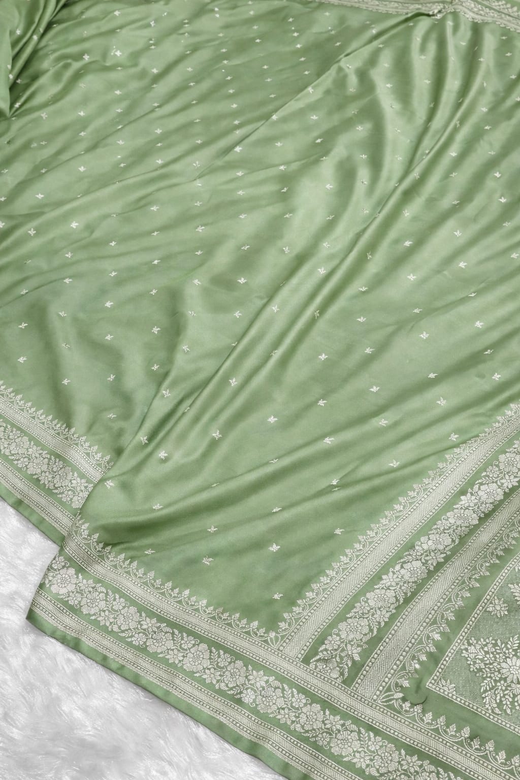 Green fabric with white patterns and border