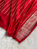 Red fabric with white intricate patterns on a white background