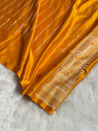 Yellow saree with intricate patterns on a white background
