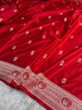 Red fabric with white floral patterns on a white background