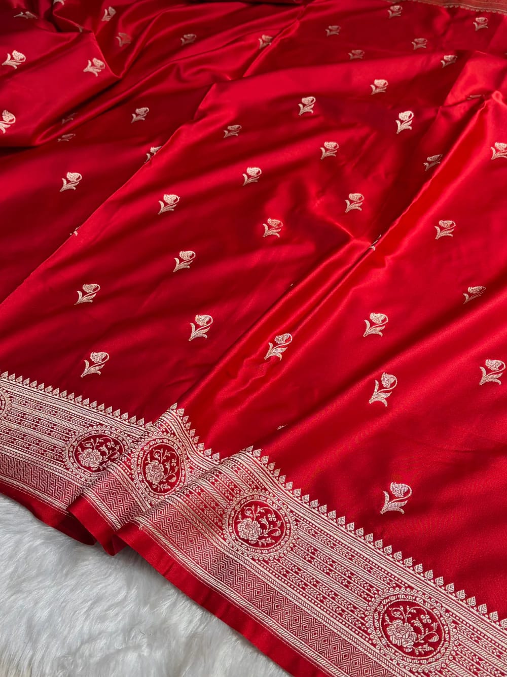Red fabric with white floral patterns on a white background