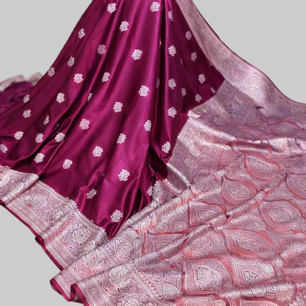 Maroon saree with white floral patterns on a white background