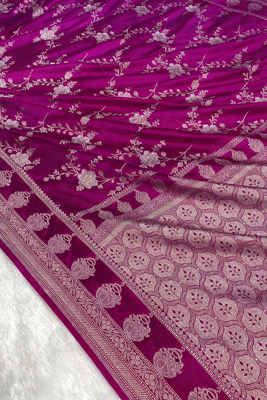 Purple fabric with intricate white patterns on a white background