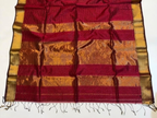 Red and gold striped fabric with a white background