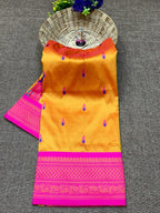 Orange saree with pink border on a gray surface