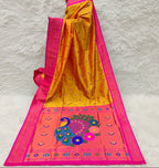 Yellow saree with pink border and peacock design in a store setting