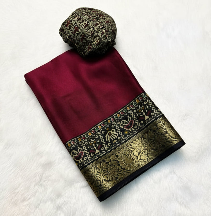 Maroon saree with black and gold border on a white background with yellow flowers