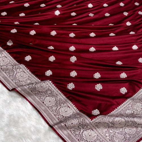Maroon fabric with silver floral patterns on a white background