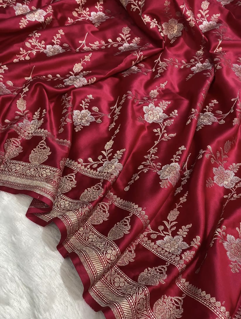 Red fabric with intricate gold embroidery on a white background