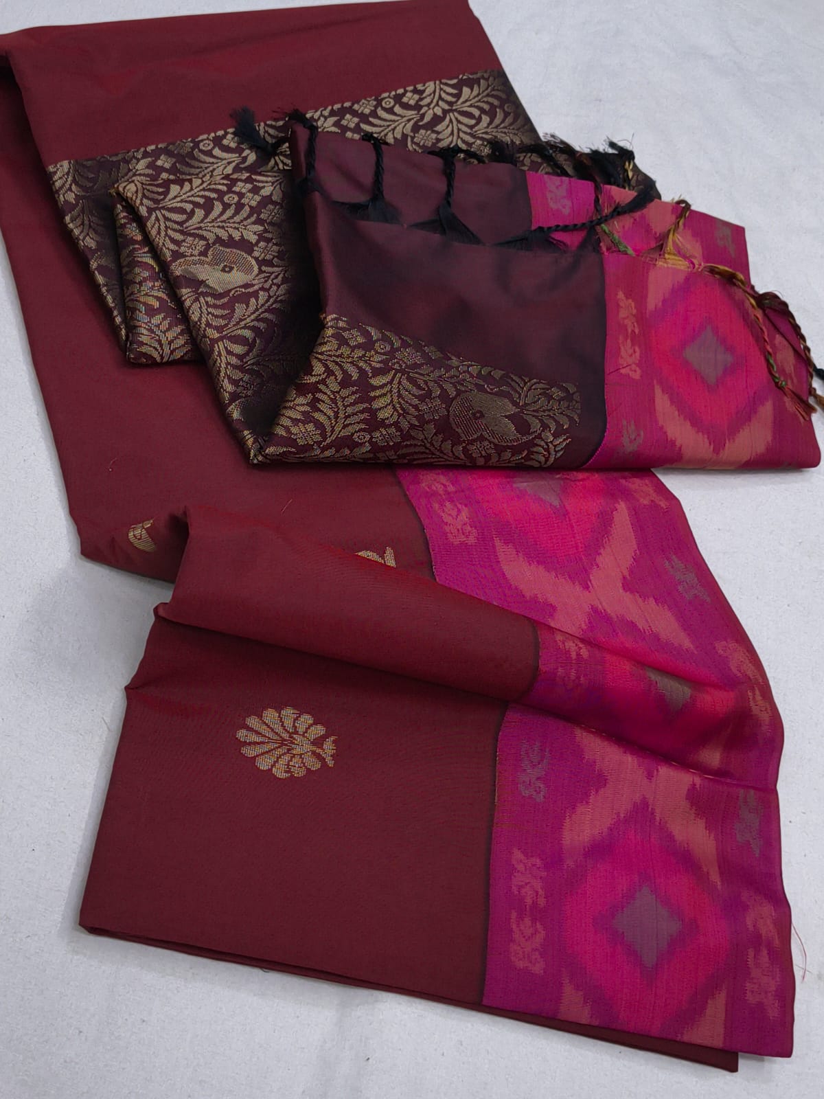 Two sarees with intricate patterns on a white background