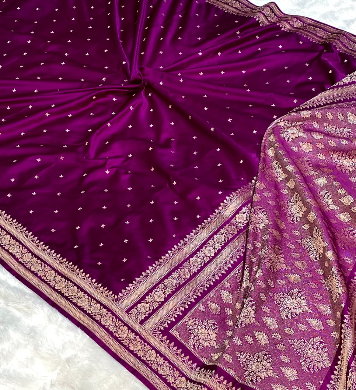 Purple saree with gold embroidery on a white background