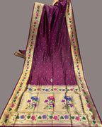 Purple saree with floral patterns on a fabric store background