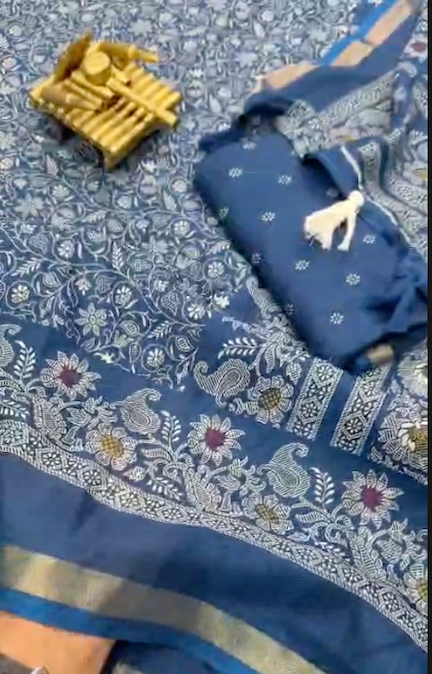 Blue saree with white patterns on a blue fabric background