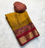 Traditional saree with intricate patterns on a white background with yellow flowers