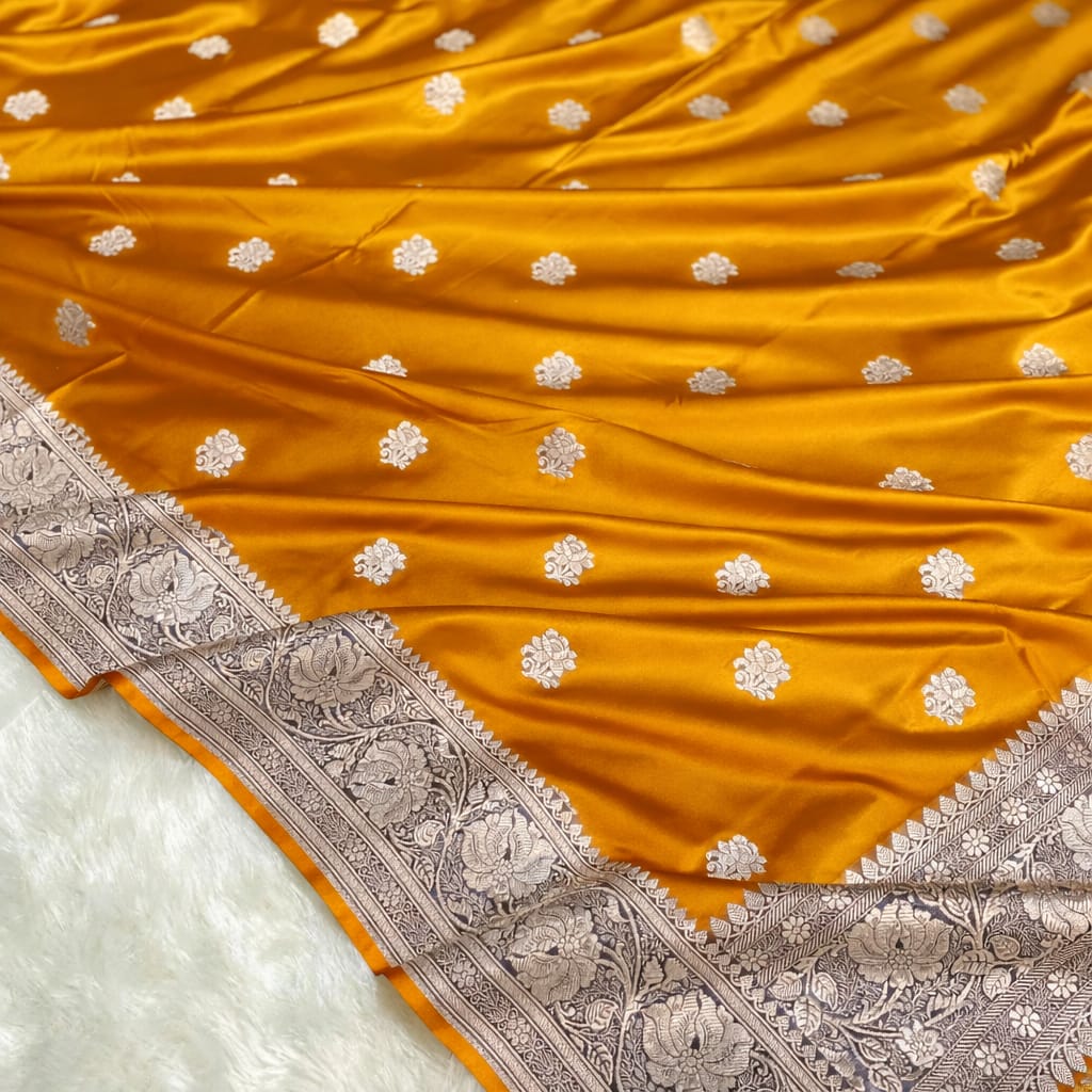Yellow saree with silver floral patterns on a white background
