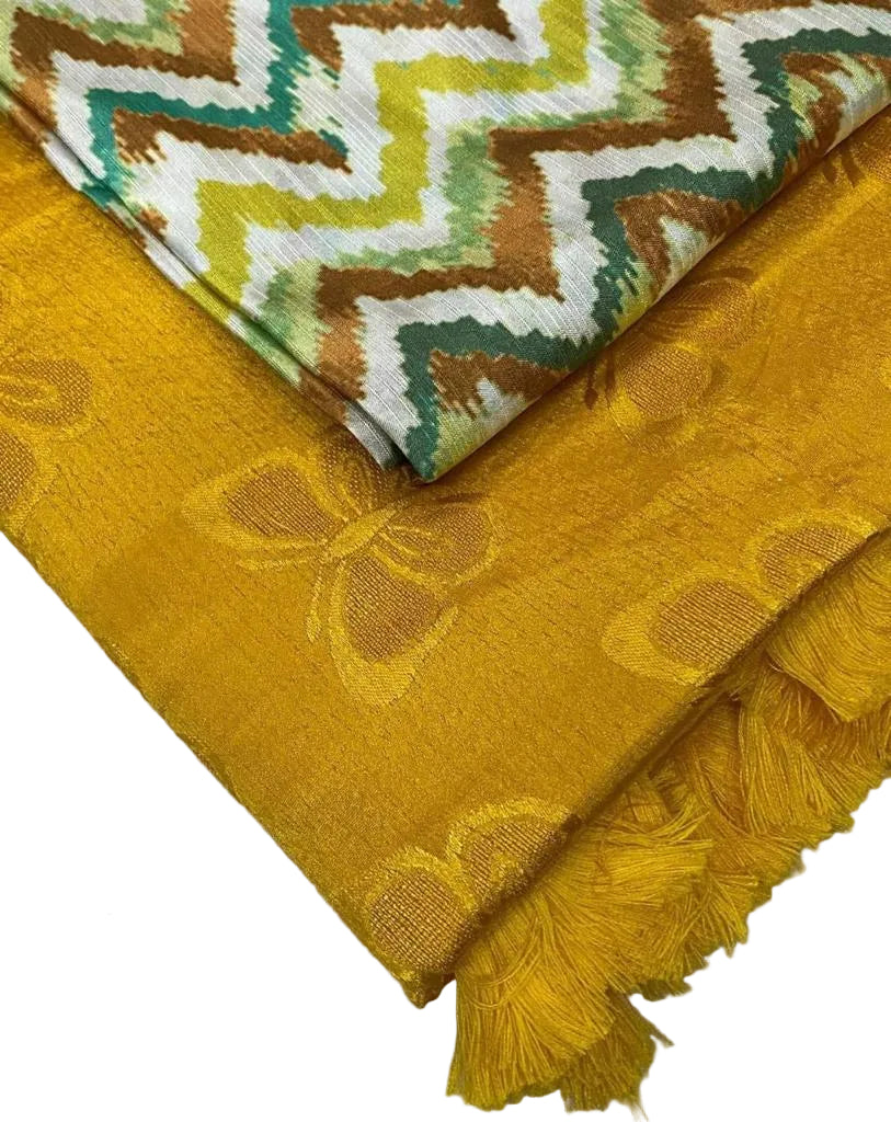 Mustard yellow fabric with butterfly pattern and green and brown zigzag pattern fabric on top.