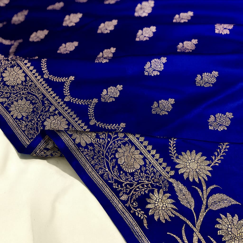 Blue fabric with white floral patterns on a white background