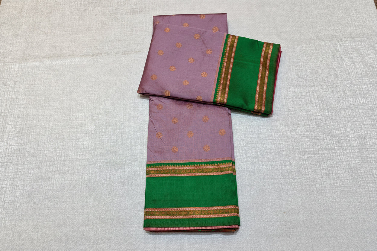Purple and green saree with floral decorations on a white background