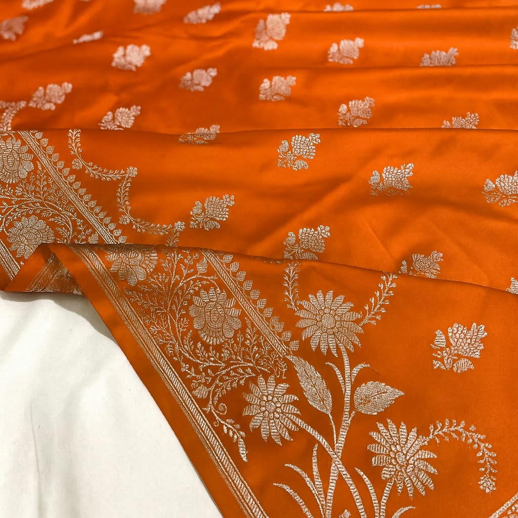 Orange fabric with white floral patterns