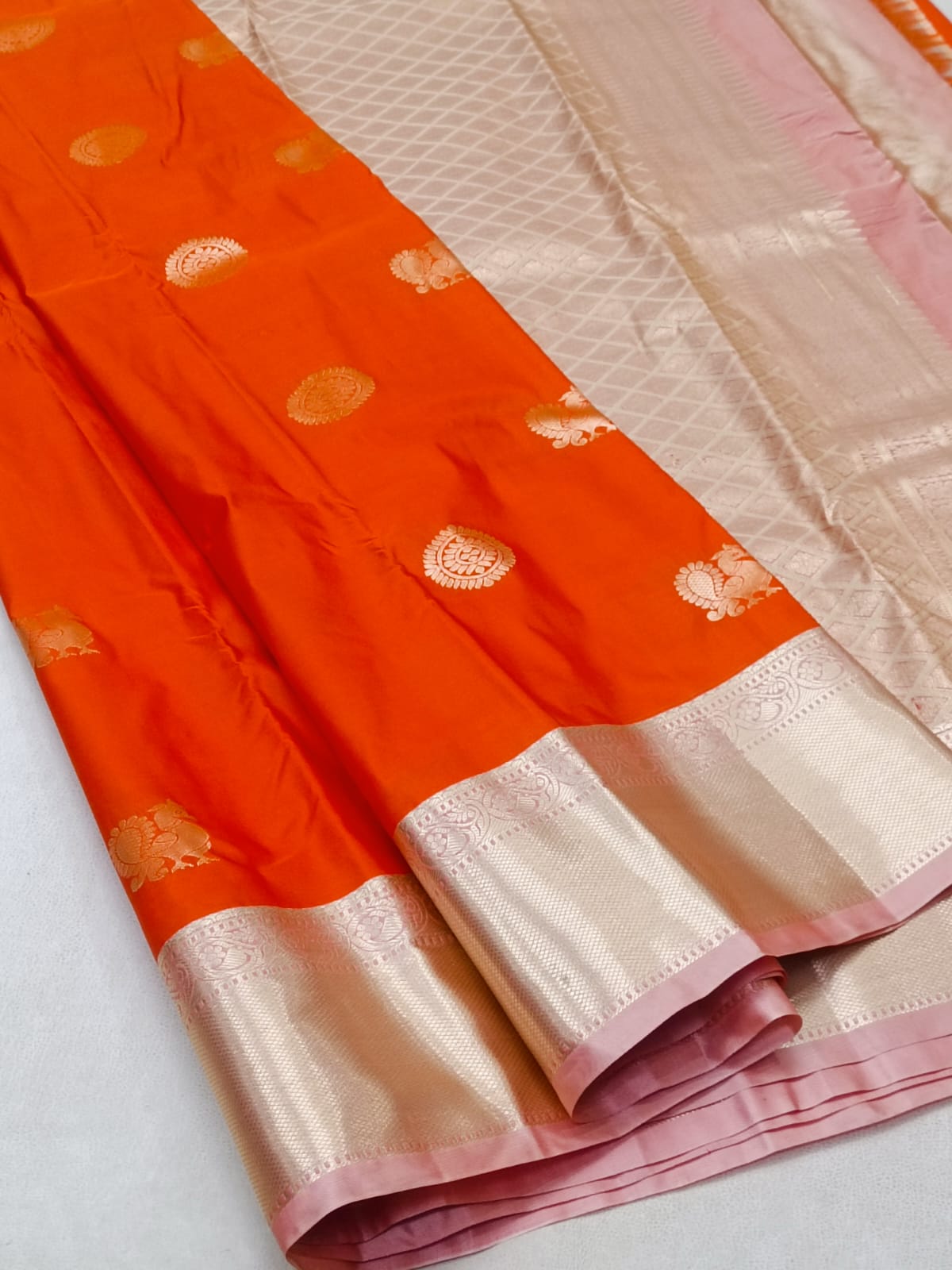 Orange and beige saree with a decorative border on a white background