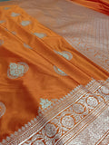 Orange saree with intricate silver patterns