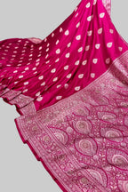 Pink saree with white patterns on a white surface
