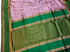 Saree with green and pink border on a white background
