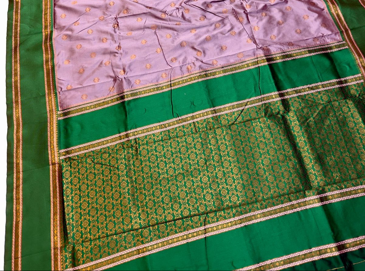 Saree with green and pink border on a white background