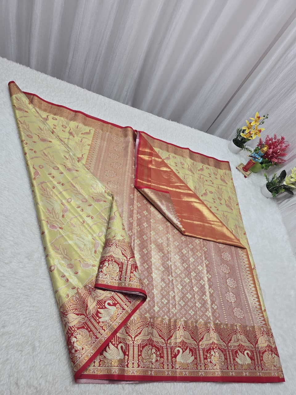 Traditional saree with intricate patterns on a white surface