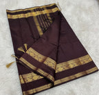 Brown saree with gold border on a tiled floor