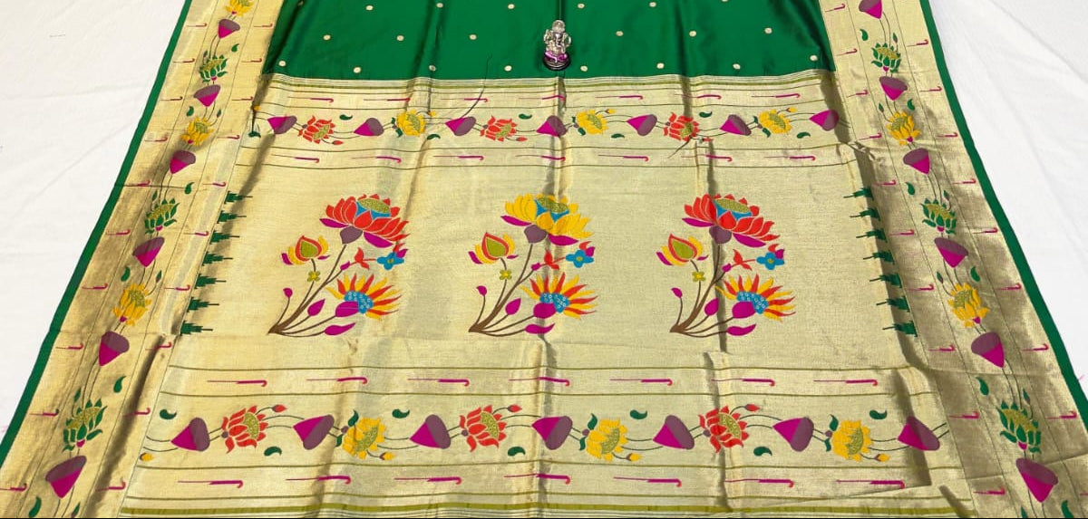 Green saree with floral patterns on a colorful background