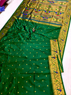 Green saree with gold border and patterns on a white background