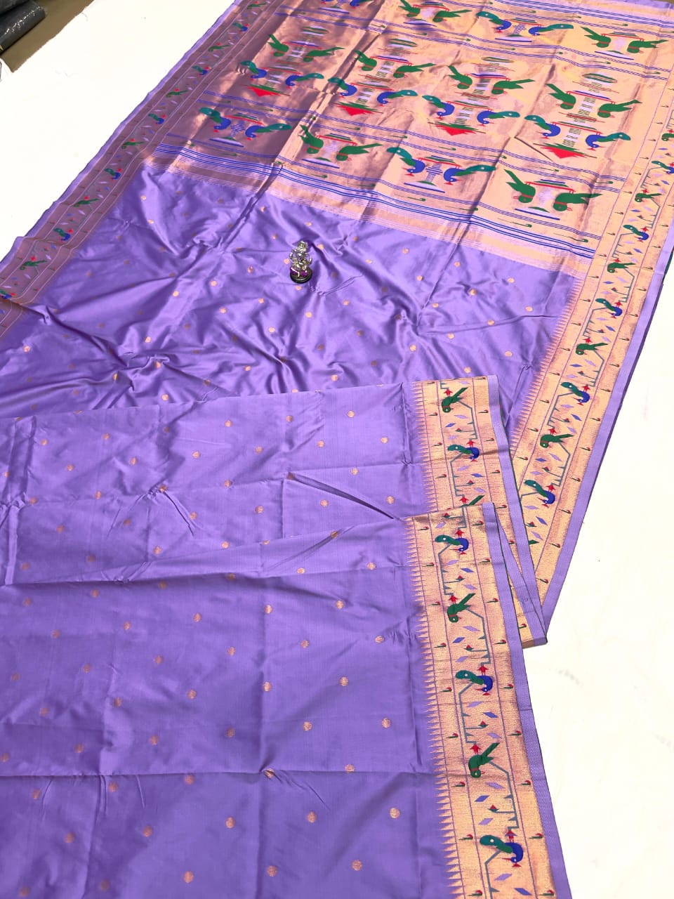 Purple fabric with colorful patterns on a white background