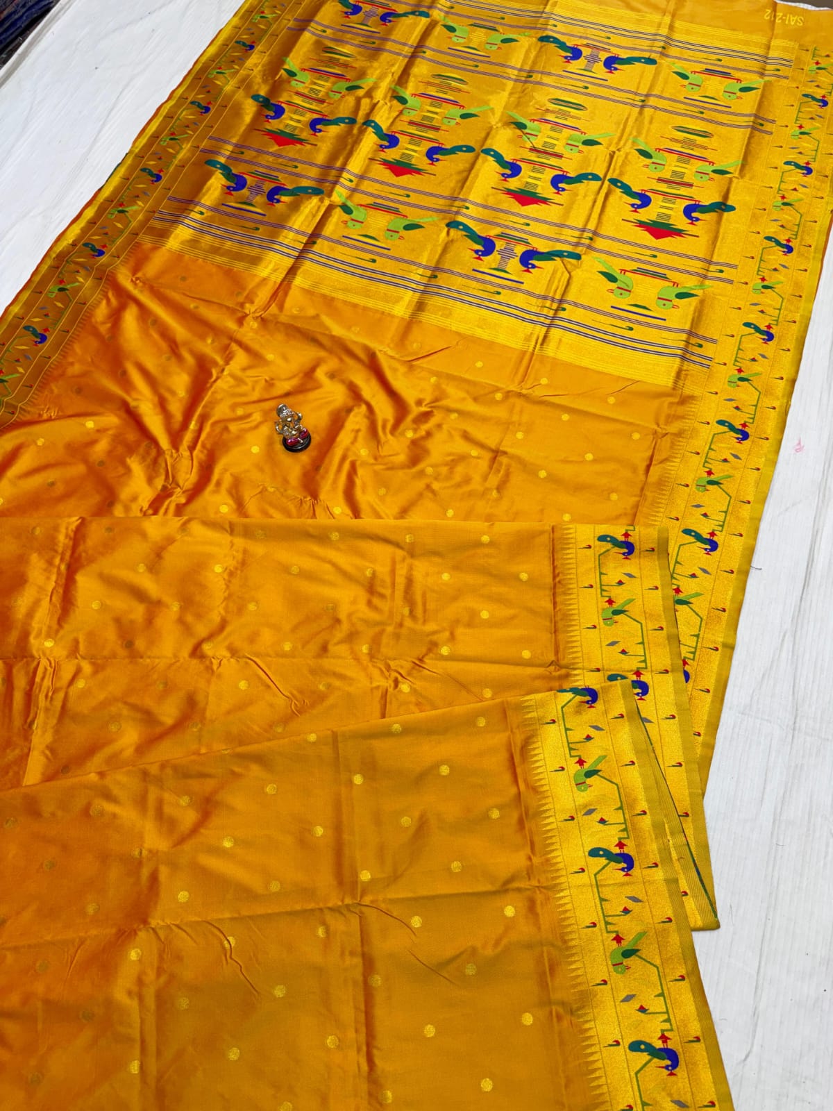 Yellow fabric with decorative patterns on a white background