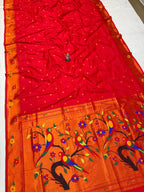 Red and orange saree with floral and bird design on a white background