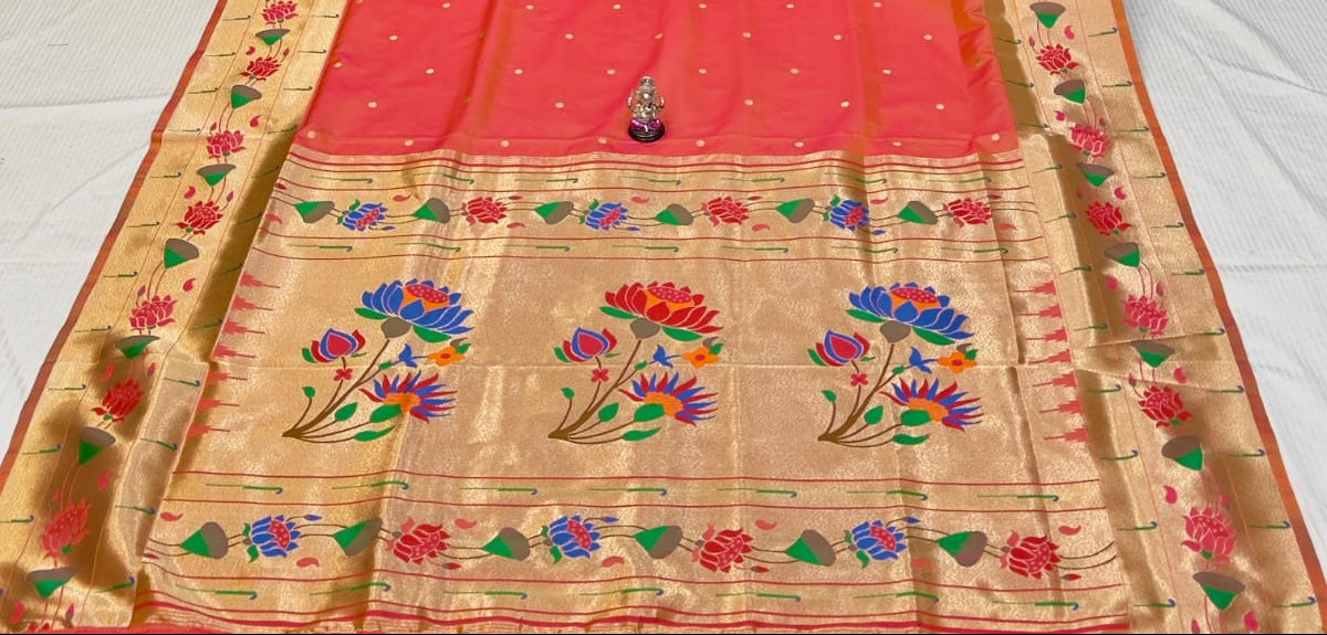 Orange saree with floral patterns on a white background