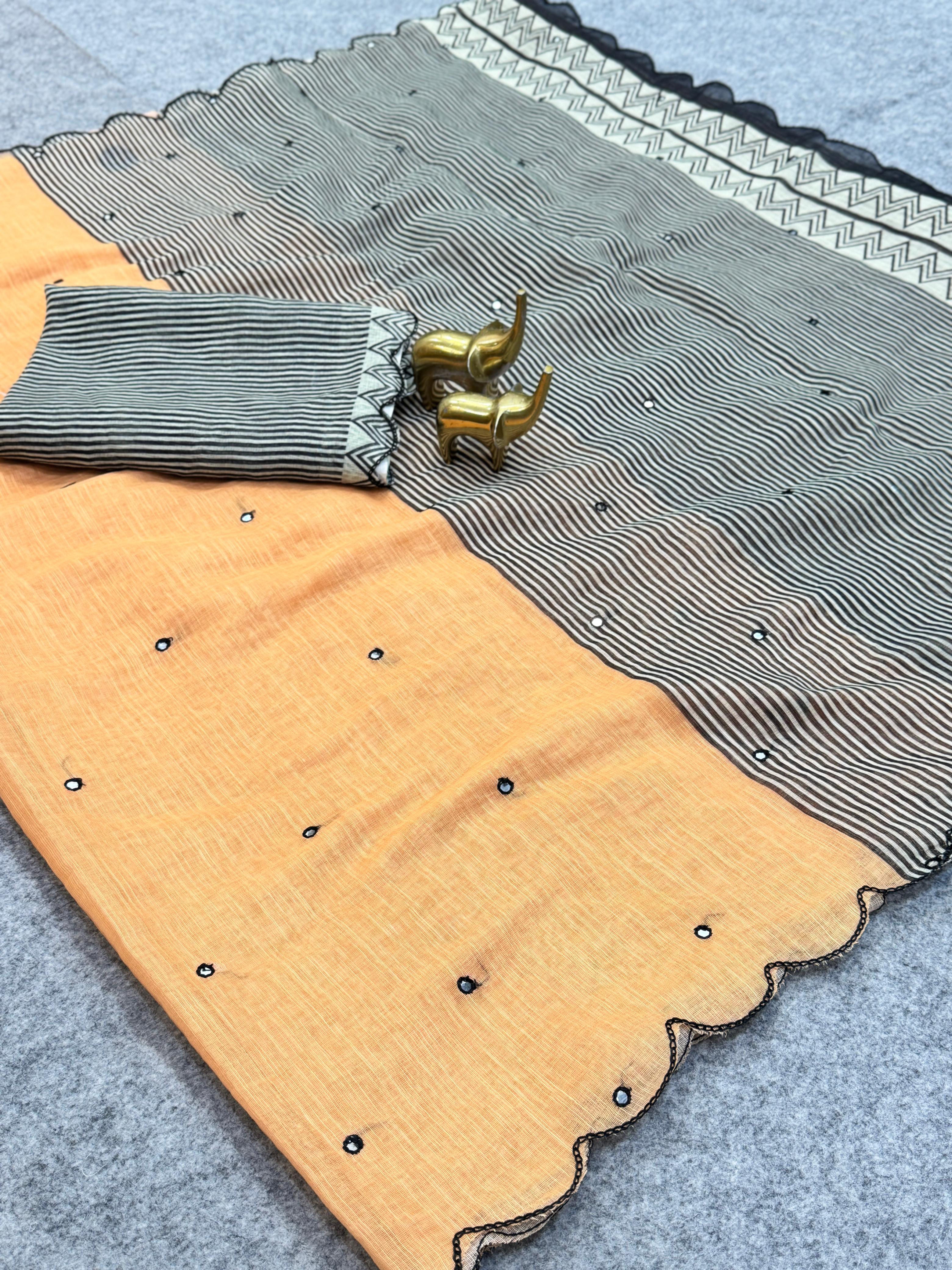 Saree with a patterned border and a plain fabric, displayed on a flat surface.