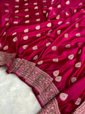 Pink saree with white patterns on a white background