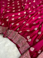 Pink saree with white patterns on a white background
