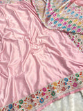 Pink fabric with floral embroidery on a white background