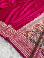 Pink fabric with intricate paisley patterns on a white background