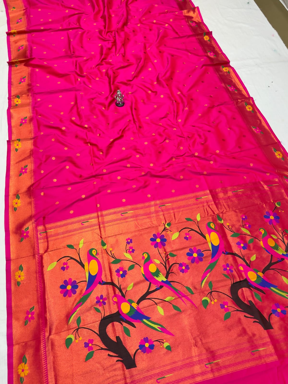 Saree with pink and orange design on a white background
