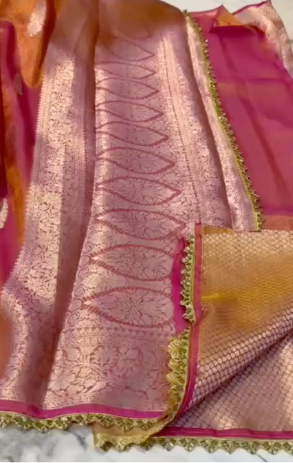 Saree with pink and gold border on a white background