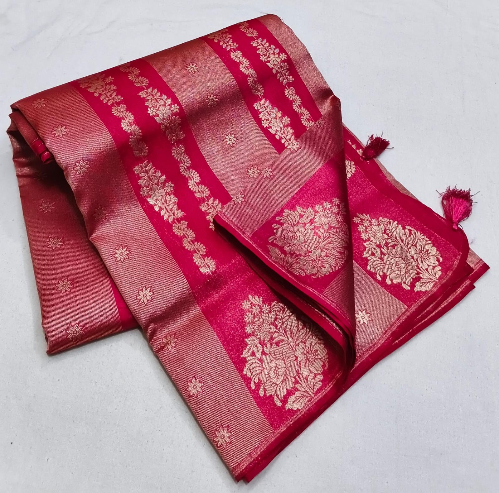 Red saree with gold patterns on a white background