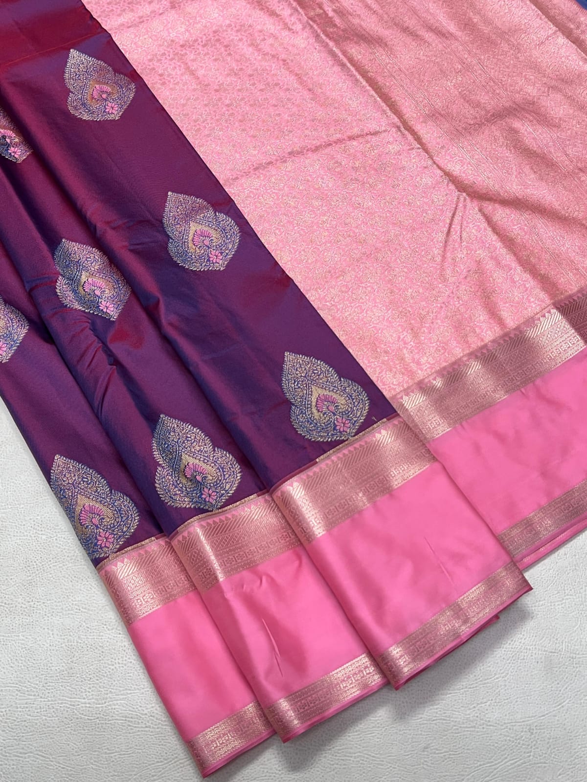 Purple and pink saree with decorative patterns on a light gray background
