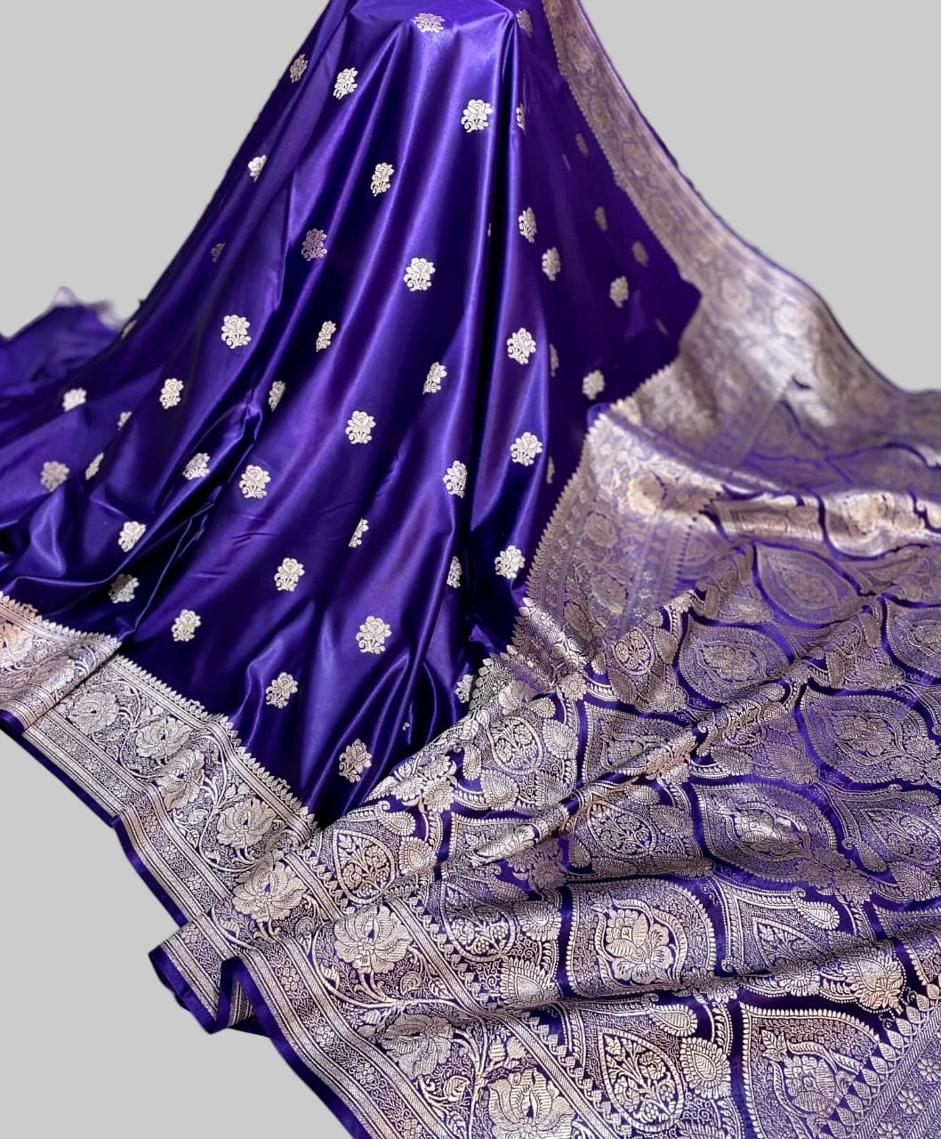 Purple saree with silver embroidery on a light background