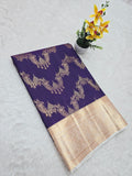 Purple saree with gold border on a white background