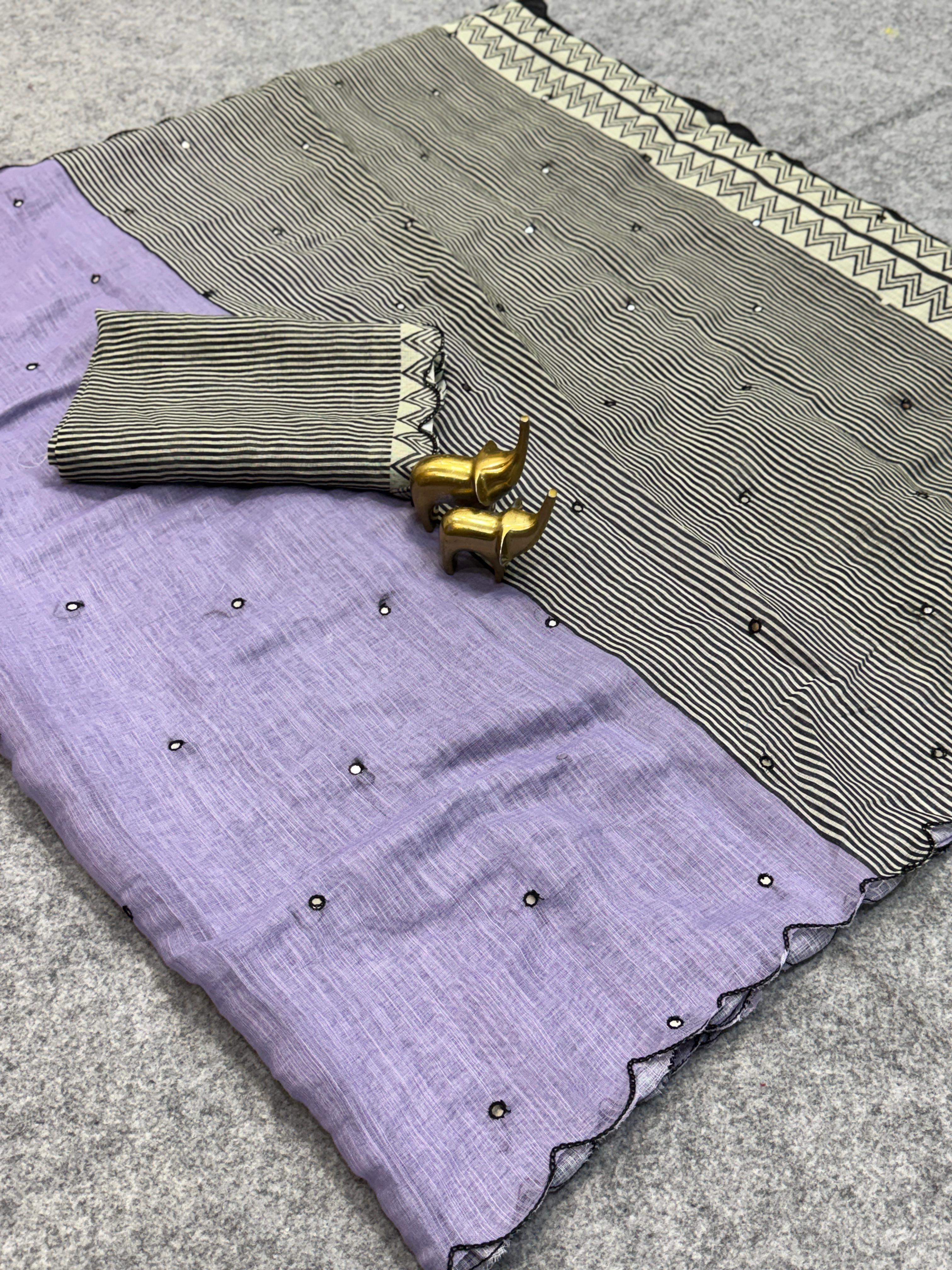 Purple fabric with gold embroidery and a gray fabric with black patterns on a textured surface.